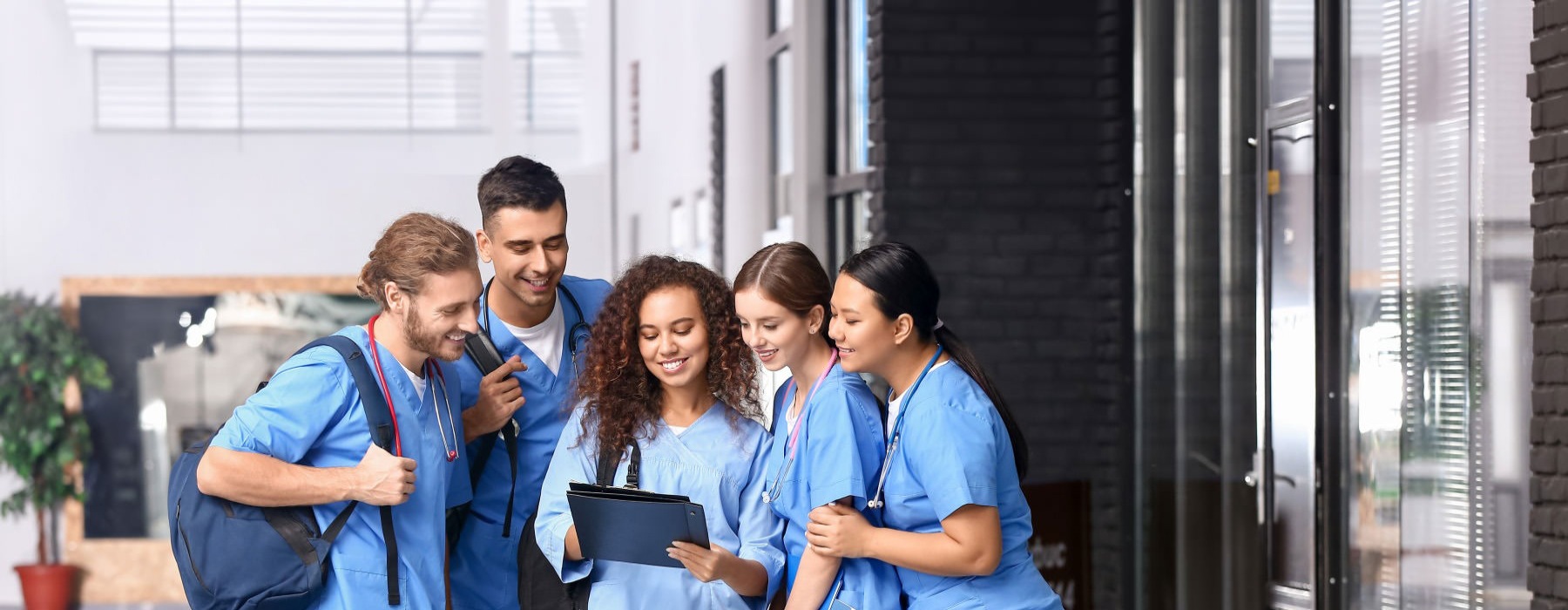 a group of nurses looking at a clipboard